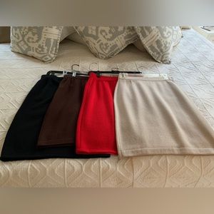 Four St. John knit pencil skirts sold in a bundle of four.